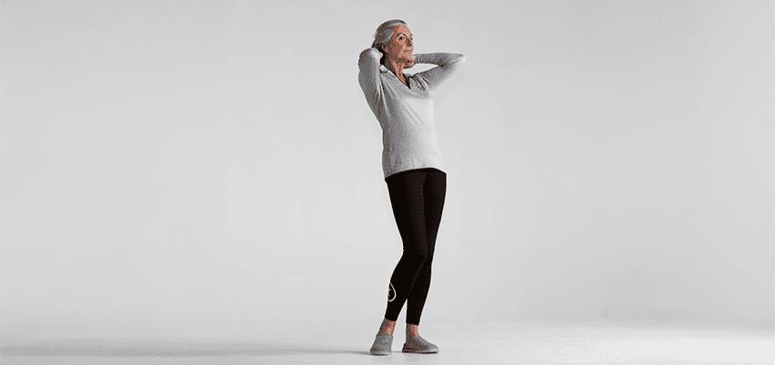 Older woman stretching in studio, Purpl discounts for disabilities and long term health conditions, mobility discounts and offers.