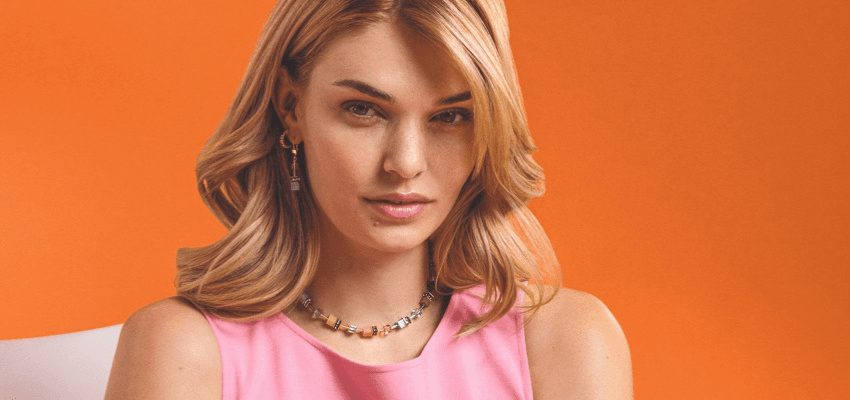 Portrait of woman in pink top, Grace & Co Purpl discounts for disabilities and long term health conditions, shopping discounts for disabled people.