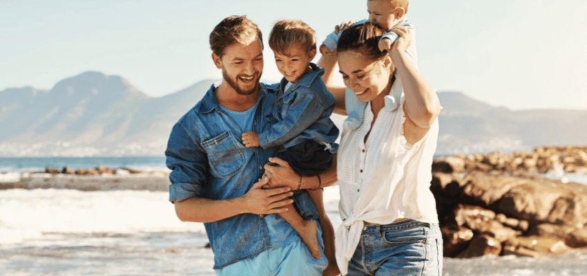 Smiling family walking on beach, Lloyds Pharmacy Purpl discounts for disabilities and long term health conditions, shopping discounts for disabled people.