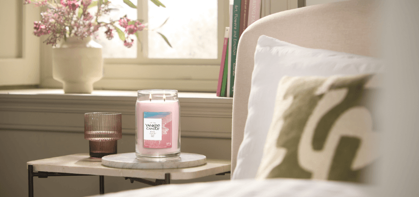 Lit Yankee Candle on bedside table, Purpl discounts for disabilities and long term health conditions, shopping discounts for disabled people.