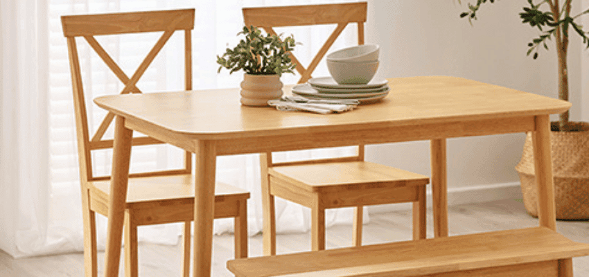 Wooden dining table with matching chairs and stacked bowls in a bright modern room Purpl discounts shopping discounts for disabled people accessibility discounts UK mobility discounts and offers savings for people with long term health conditions cost of living help for disabled people