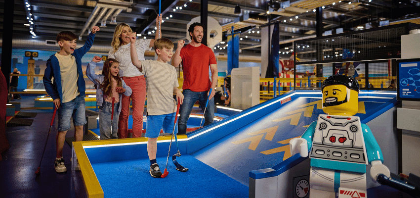 Family playing mini golf at LEGOLAND, Purpl discounts for disabilities and long term health conditions, disabled travel discounts UK.