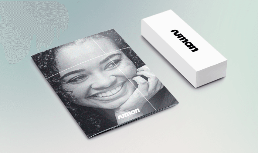 Smiling woman on glossy Numan booklet with matching white Numan box on pastel background. Health and wellness starter kits. Medical support for men and women. Online health consultations. Mobility discounts and offers.