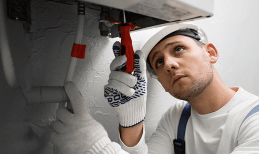 Boiler repair engineer fixing a broken heating system using specialist tools indoors. Home boiler cover for disabled people UK with affordable central heating protection plans and emergency breakdown services.