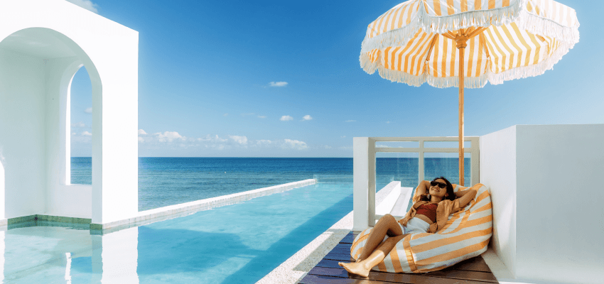 Woman relaxing beside a luxury infinity pool, Purpl discounts for disabilities and long term health conditions, mobility discounts and offers.