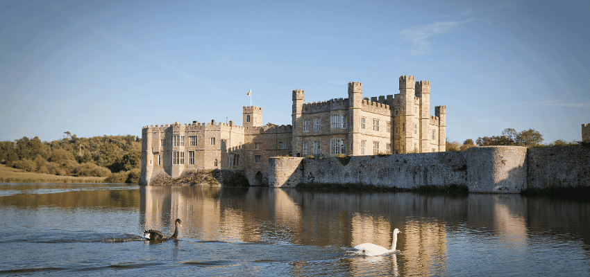 Leeds Castle over a calm moat at sunset, Purpl discounts for disabilities and long term health conditions, disabled travel discounts UK.