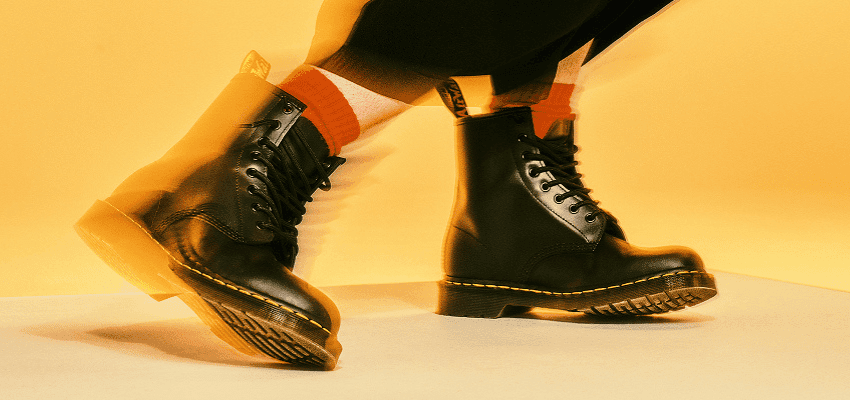 Black Dr. Martens boots in motion, Purpl discounts for disabilities and long term health conditions, mobility discounts and offers.