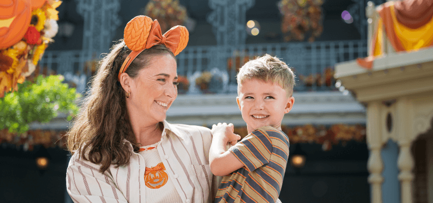 Mother and son smile at Disney park, Walt Disney Travel Company; Purpl discounts for disabilities and long term health conditions, disabled travel discounts UK.