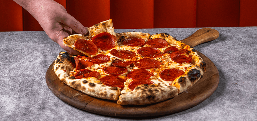 Pepperoni pizza on wooden board, Purpl discounts for disabilities and long term health conditions, mobility discounts and offers.