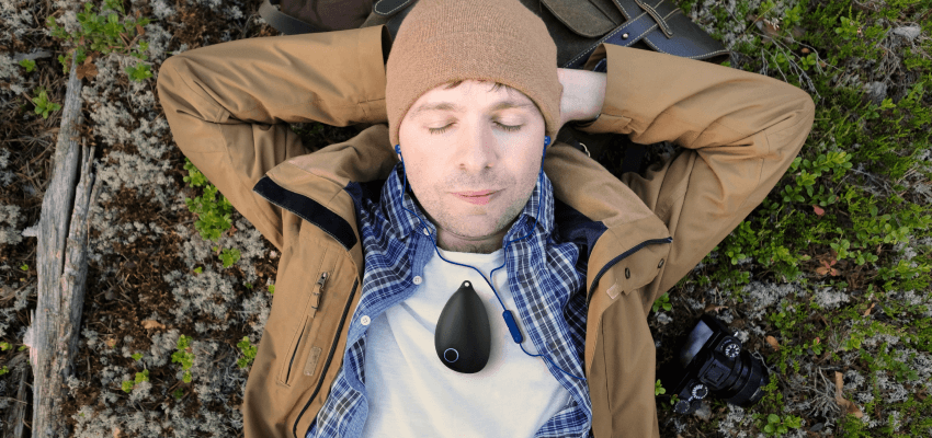Man relaxing outdoors wearing Sensate device, Purpl discounts for disabilities and long term health conditions, mobility discounts and offers.