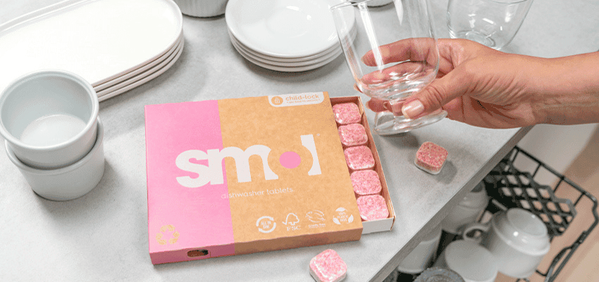 Hand placing glass by smol dishwasher tablets, Purpl discounts for disabilities and long term health conditions, mobility discounts and offers.