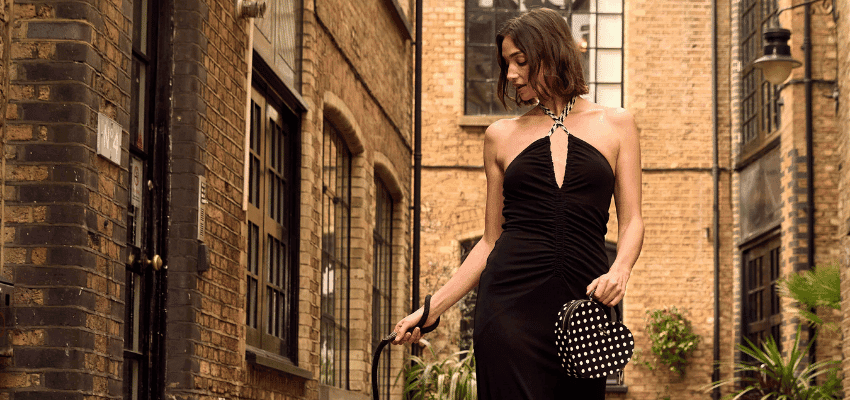 Woman in black dress on city street, Brand Alley Purpl discounts for disabilities and long term health conditions, shopping discounts for disabled people.