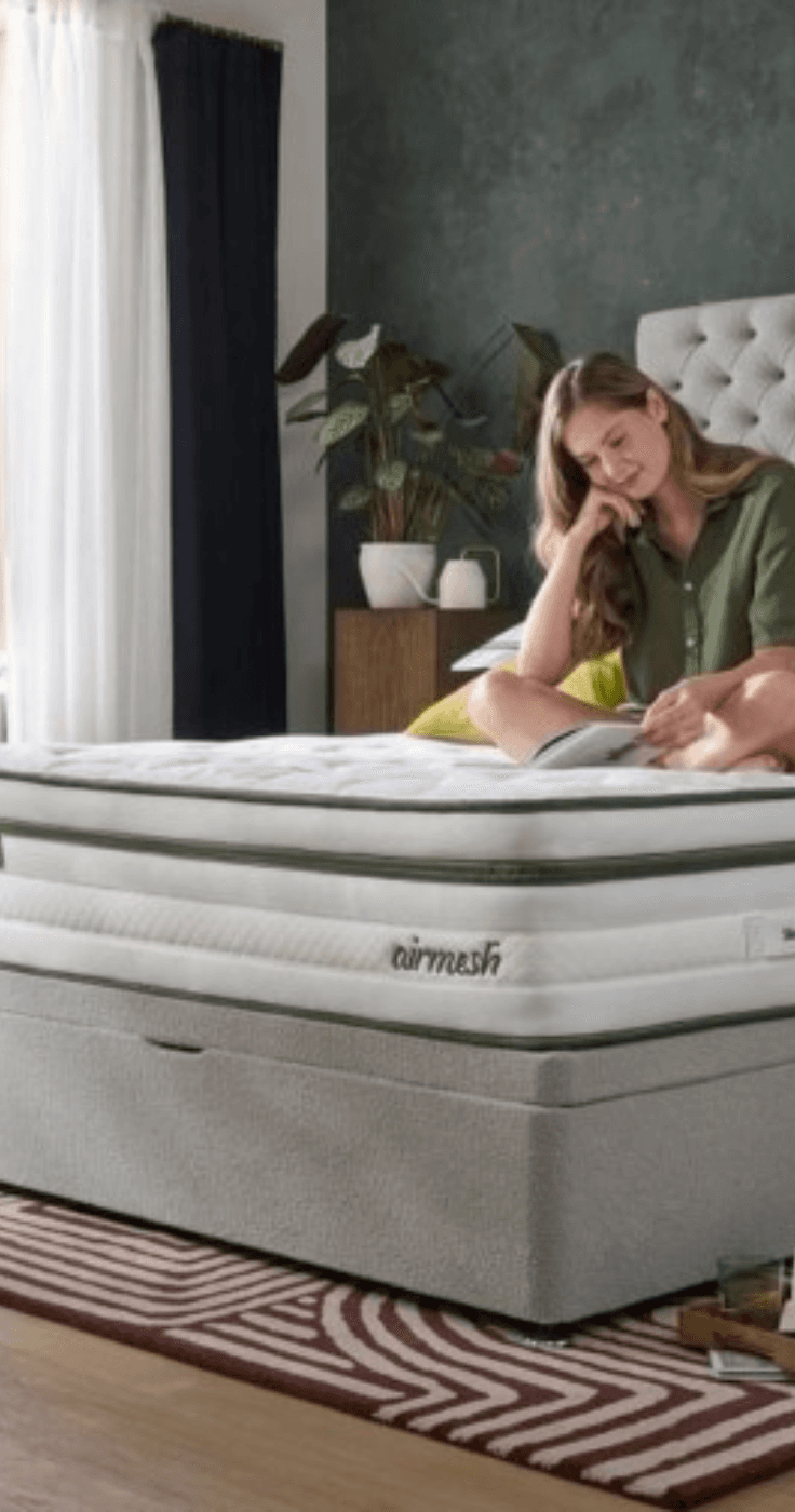 A woman relaxing on a Silentnight mattress in a cosy bedroom, emphasising the brand’s focus on comfort and restful sleep. Discounts for disabled people available.