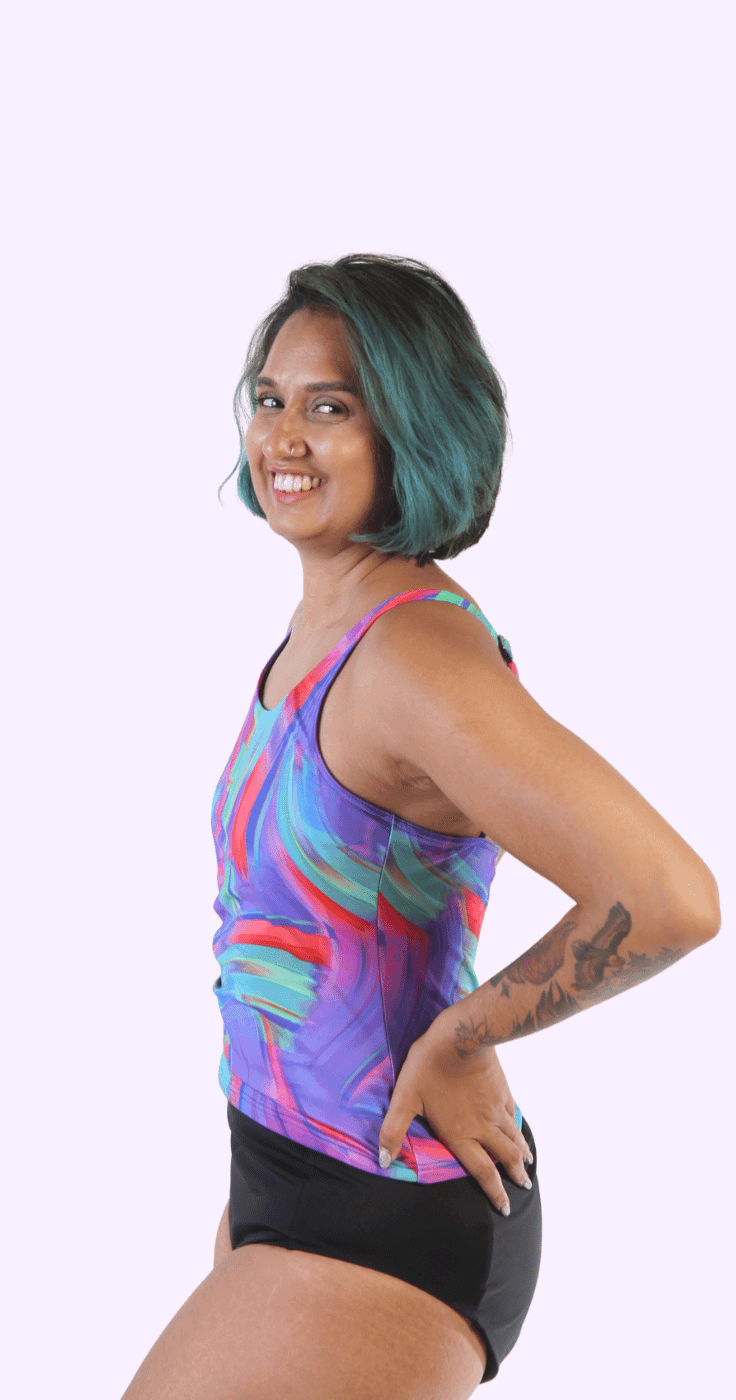 Smiling woman wearing a colourful adaptive swimsuit, promoting Incy Wincy adaptive swimwear through Purpl’s disability discounts for comfort and confidence.