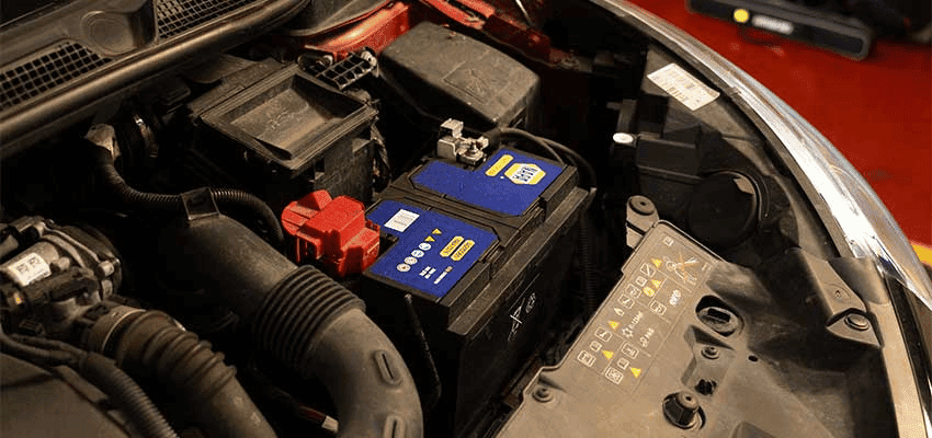 Car engine bay with battery at Kwik Fit offering Purpl discounts for disabilities and long term health conditions, shopping discounts for disabled people.