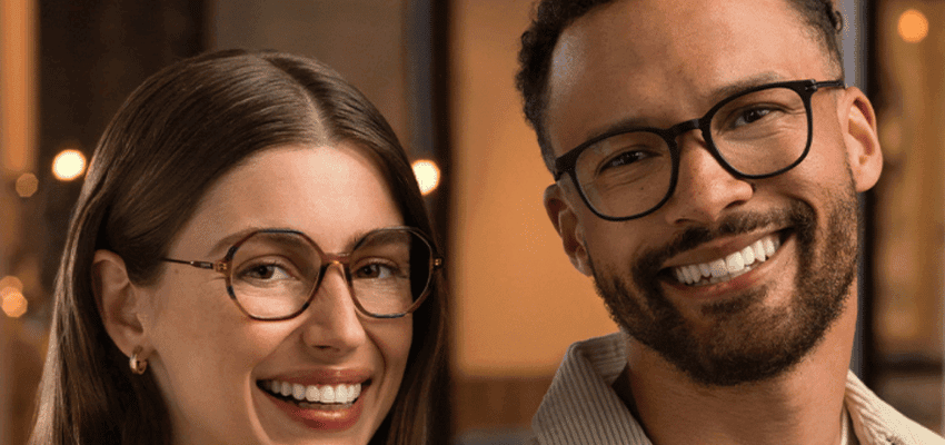 Two people smiling while wearing stylish eyeglasses from Vision Express, featuring exclusive discounts on prescription glasses for disabled people in the UK, helping to save on essential eyewear.