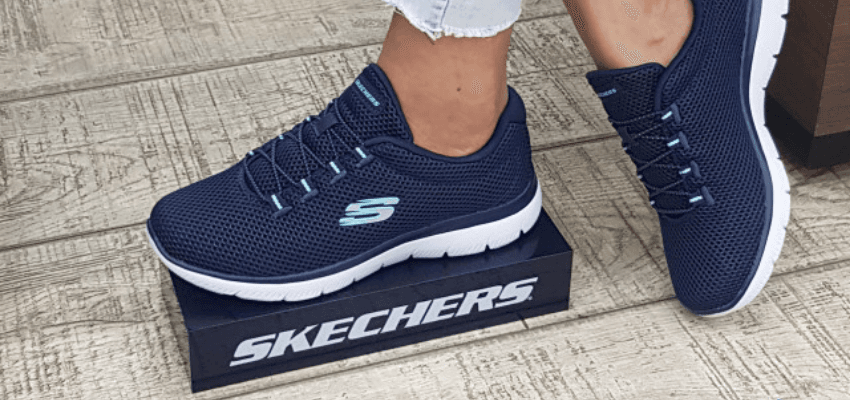 Person wearing navy Skechers trainers standing on Skechers box, eBay Shopping Discounts for Disabled People and Footwear Offers UK.