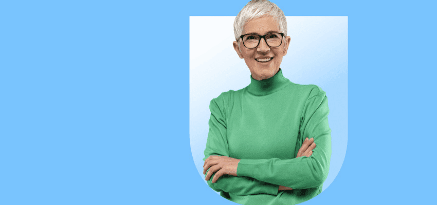 Smiling older woman wearing glasses and green jumper on blue background promoting energy savings with disabled discounts in the UK