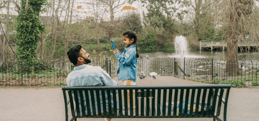 Father and daughter by a park lake, EE Purpl discounts for disabilities and long term health conditions, mobility discounts and offers.