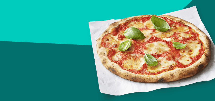 Hot margherita pizza with fresh basil from Deliveroo, showing accessible takeaway options with everyday savings for people with long term health conditions.