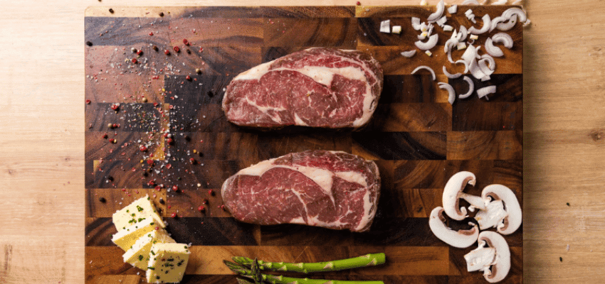 Two raw steaks on chopping board, Campbells Meat Purpl discounts for disabilities and long term health conditions, shopping discounts for disabled people.