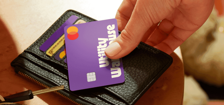 Hand holding Utility Warehouse card in wallet, Purpl discounts for disabilities and long term health conditions, mobility discounts and offers.