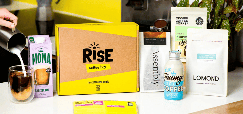 Coffee subscription box from RISE Coffee Box surrounded by artisan coffee brands including MOMA Barista Oat, Mission Coffee Works, Lomond, and Jimmy’s Iced Coffee. Promotes Purpl’s exclusive disabled member discount on sustainable coffee subscriptions and ethical drinks for home delivery in the UK.