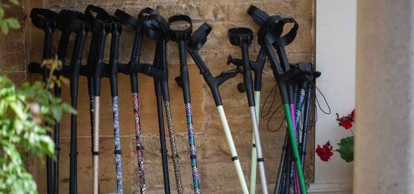 Colourful crutches leaning against a wall, Cool Crutches, Purpl discounts for disabilities and long term health conditions, mobility discounts and offers.