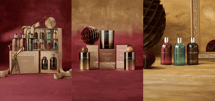 Elegant bottles of Molton Brown bath and shower gels in rich colours against a warm background, surrounded by bubbles and festive packaging. Represents luxury self-care and premium beauty offers available through Purpl Disabled Discounts, including exclusive savings on Molton Brown gift sets and fragrances.