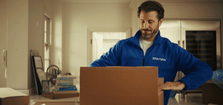 Man packing a cardboard box, AnyVan Purpl discounts for disabilities and long term health conditions, disabled travel discounts UK.