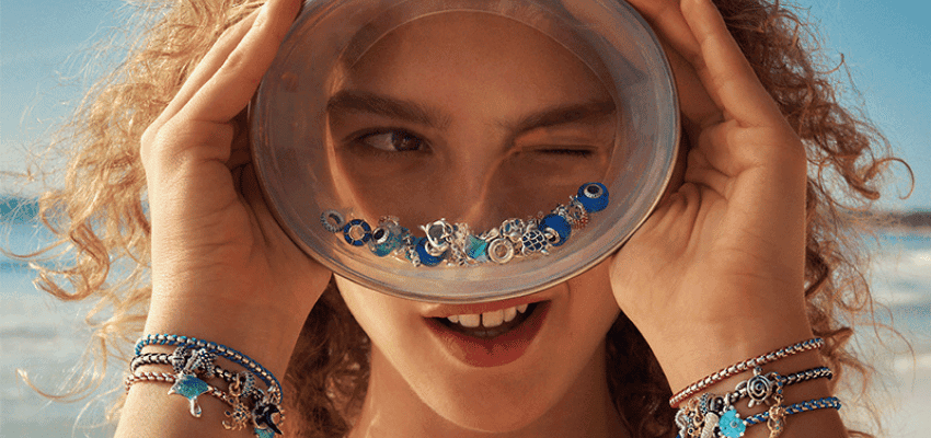 Woman holding Pandora charm bowl to eye, Purpl discounts for disabilities and long term health conditions, mobility discounts and offers.