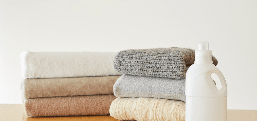 Stacked towels and laundry detergent on table, eBay Purpl discounts for disabilities and long term health conditions, shopping discounts for disabled people.