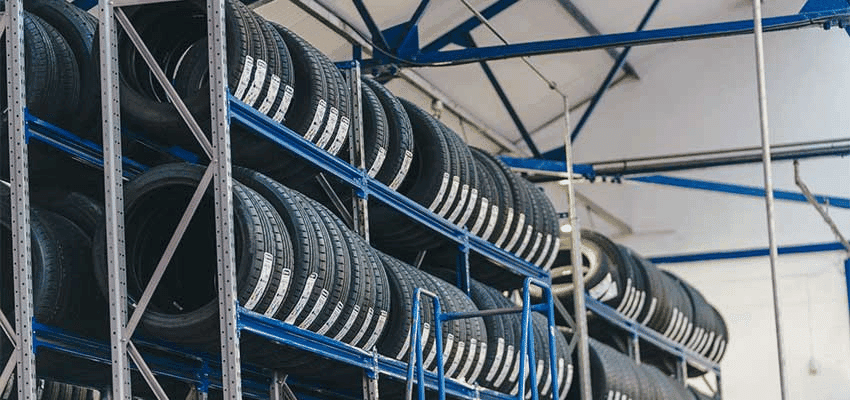 Shelves stacked with rows of car tyres at Kwik Fit: Purpl discounts for disabilities and long term health conditions, mobility discounts and offers.