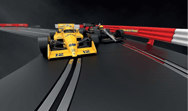 Two toy slot cars racing on track