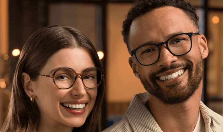 Two people smiling while wearing stylish eyeglasses from Vision Express, featuring exclusive discounts on prescription glasses for disabled people in the UK, helping to save on essential eyewear.