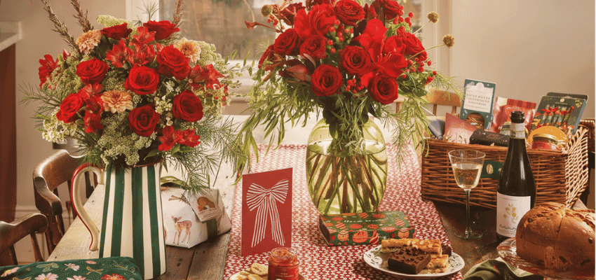 Festive Bloom & Wild Christmas flower bouquets displayed in colourful vases on a kitchen counter, showcasing vibrant gifting options with Bloom & Wild disability discount savings, perfect for accessible Christmas gift ideas and seasonal offers for disabled people.