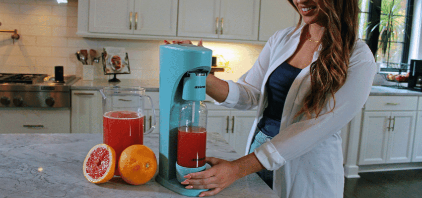 Woman making citrus drink with Drinkmate machine, Purpl discounts for disabilities and long term health conditions, mobility discounts and offers.