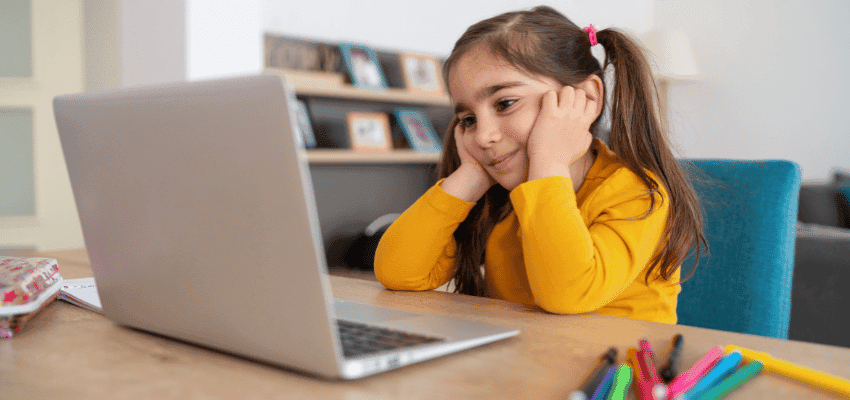 Child using laptop for Young Wellbeing Hub emotional wellbeing and disability support.