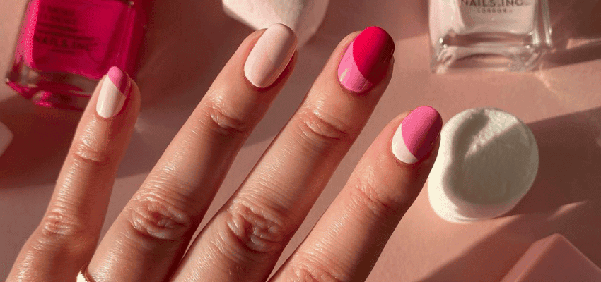 Close-up of pink and nude Nails Inc manicure on hand, accessible beauty savings and disability discounts.