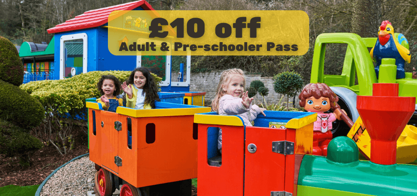 Smiling children on fun Legoland train ride with £10 off adult and pre schooler pass, Shopping Discounts for Disabled People and Family Day Out Offers UK.