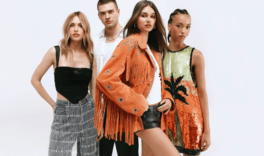 A diverse group of four fashionably dressed young adults poses confidently. The two women on the left wear stylish separates; the man in the middle wears a white jacket, and the woman on the right wears a sparkly, colourful dress with a tropical pattern.