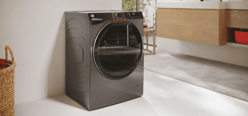 Stylish black Hoover washing machine in a modern home laundry area, part of Purpl disabled household appliance discounts and offers.