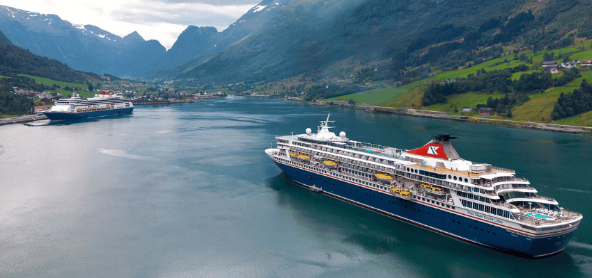 Fred Olsen cruise ships sailing through scenic fjord landscape promoting accessible cruise experiences with disabled travel discounts in the UK
