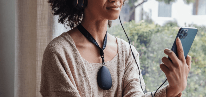 Woman wearing Sensate device and headphones, Purpl discounts for disabilities and long term health conditions, mobility discounts and offers.