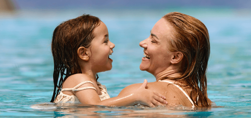 Mother and daughter swimming together, loveholidays Purpl discounts for disabilities and long term health conditions, disabled travel discounts UK.