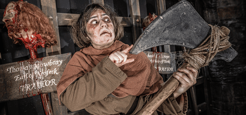 The York Dungeon disability discount with Purpl discounts, scary actor holding axe in haunted dungeon setting.