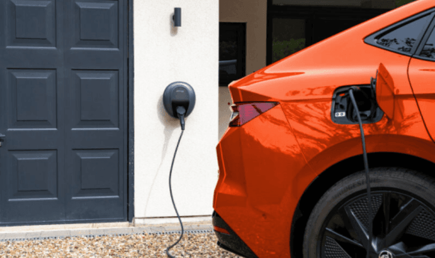 Orange electric car charging at home using a Pod Point EV charger. Accessible energy savings and mobility discounts for disabled drivers through Purpl.