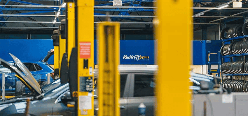 Kwik Fit garage with cars and yellow lifts, Purpl discounts for disabilities and long term health conditions, mobility discounts and offers.