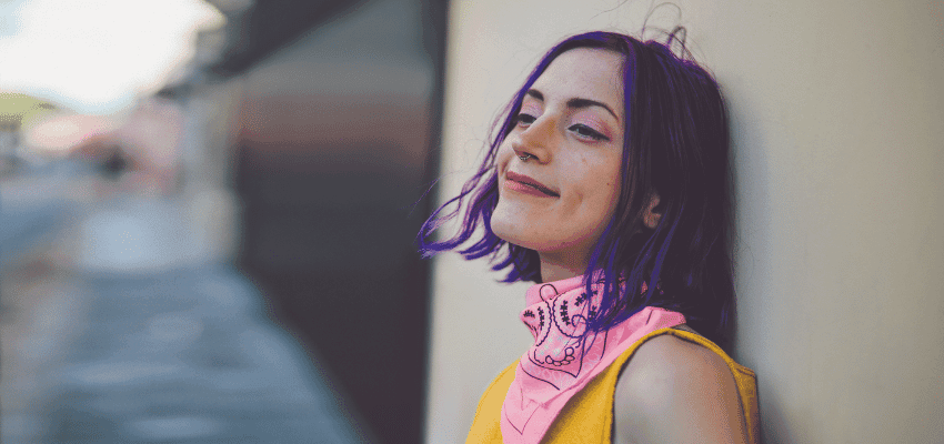 Smiling woman in pink bandana, Holland & Barrett Purpl discounts for disabilities and long term health conditions, mobility discounts and offers.