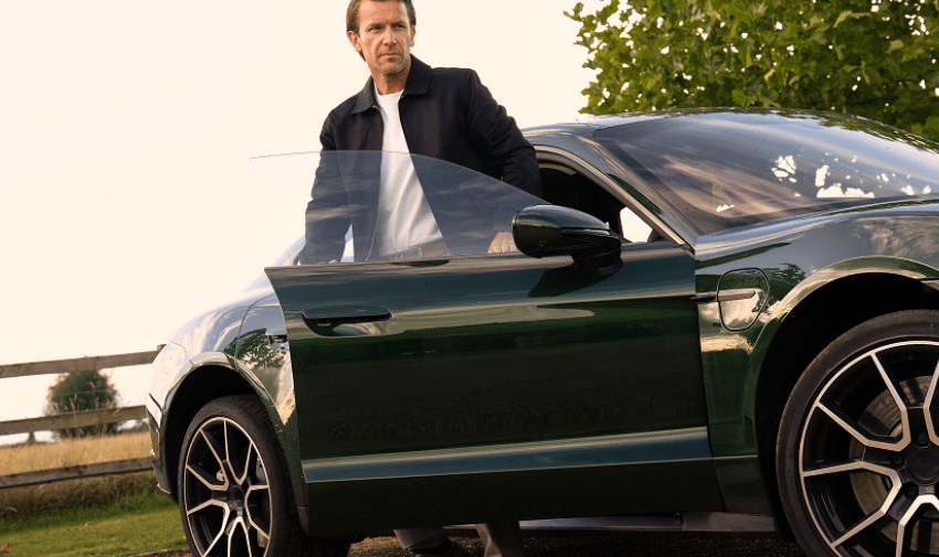 Man driving a modern vehicle with countryside view ahead, highlighting Carwow motoring deals and mobility offers for disabled drivers in the UK